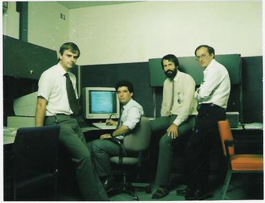 Four men with some computer equipment