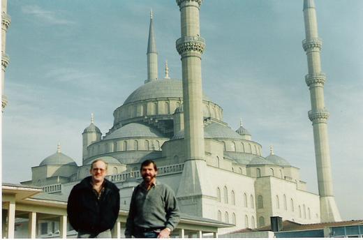 Two men in front of a mosque